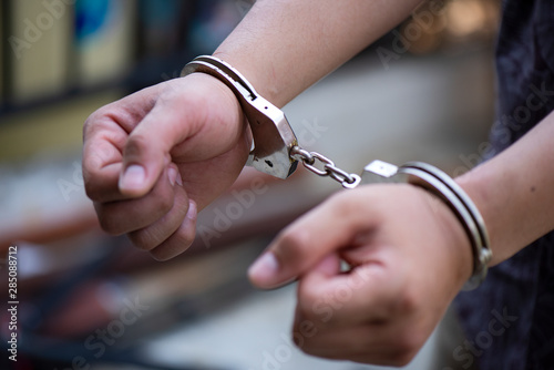 Hand close up handcuffs robber prisoner