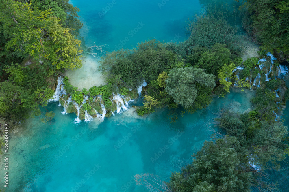 Aerial view of turquoise waters of Plitvice Lakes on a sunny summer day. Plitvice National Park, Croatia.