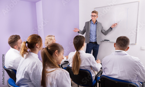 Male teacher giving presentation for students