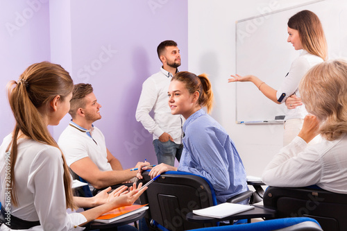 Group of students with teacher in break between lessons indoors