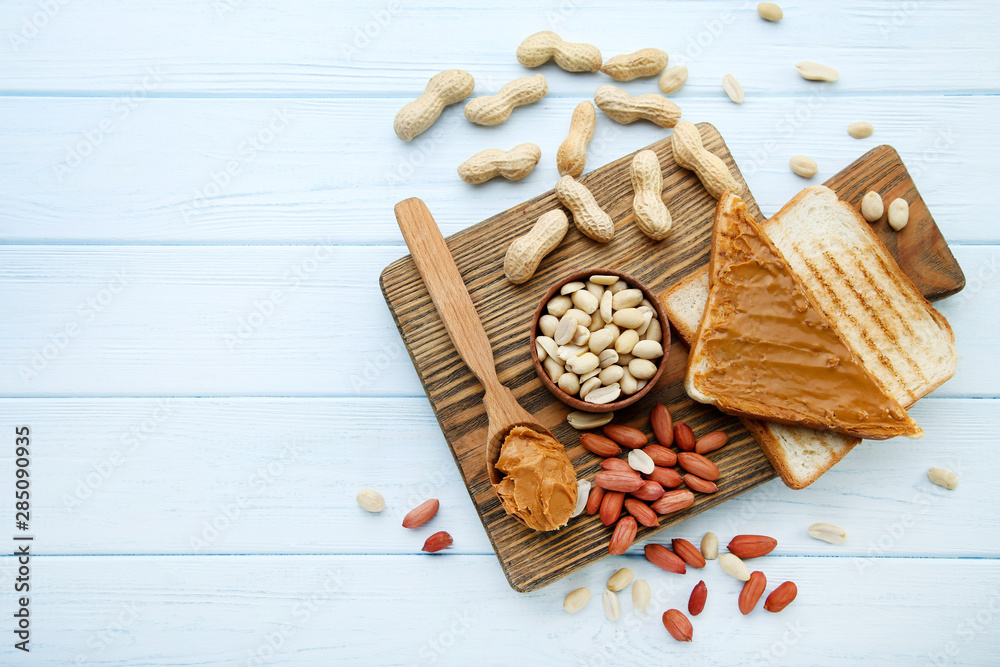 Peanut butter with bread and nuts on wooden table Peanut butter with bread and nuts on wooden table