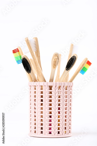 Bamboo toothbrushes in basket isolated on white background