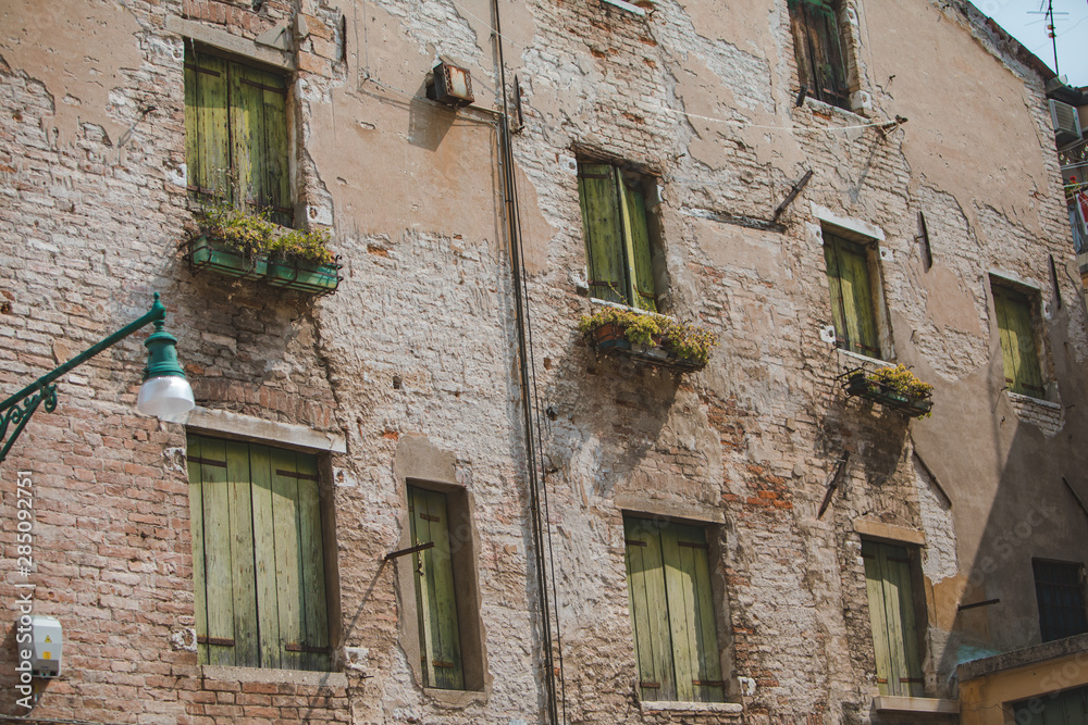 view of old break wall with windows with shutters