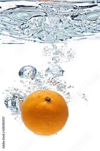 A background of splash forming after orange is dropped into it.