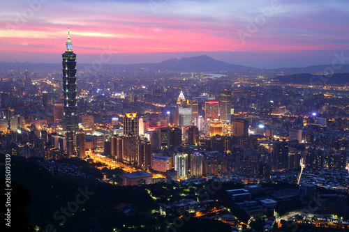 Panoramic aerial view of Downtown Taipei City at dusk, with landmark tower in Xinyi Commercial District ~A romantic evening in Taipei, capital city of Taiwan, with dramatic rosy afterglow in the sky