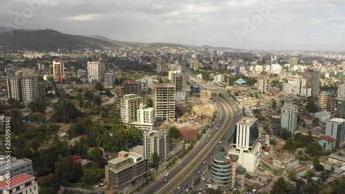 Aerial view flying over main highway through central Addis Ababa, urban development and transportation Ethiopia photo