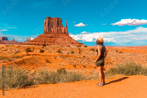 A girl in a black T-shirt in Monument Valley National Park in The Mittens and Merrick Butte point. Utah