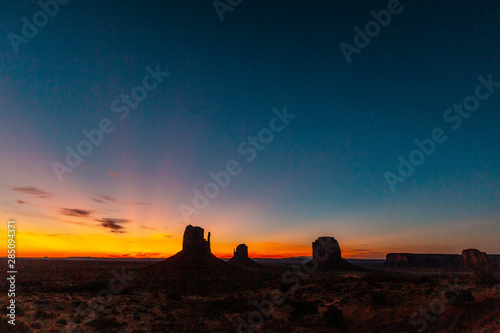 Panoramic of the first pink sunrise lights at Monument Valley in the beautiful August sunrise without clouds  Utah