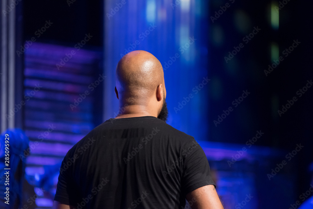 Indoor Portrait of a Bald African American Man with a Beard Facing Away from the Camera Indoor Portrait of a Bald African American Man with a Beard Facing Away from the Camera