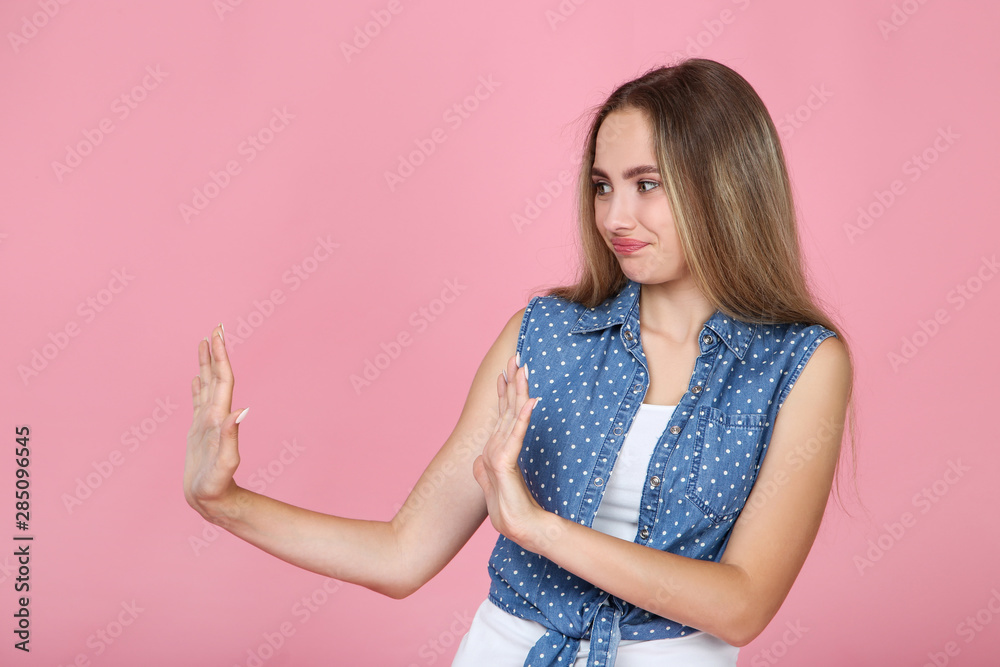 Beautiful young woman on pink background