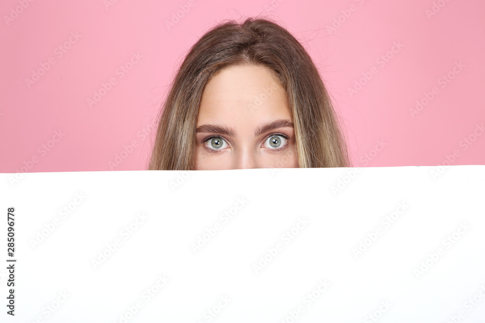Beautiful young woman holding white blank board on pink background Beautiful young woman holding white blank board on pink background