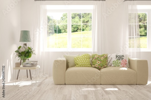 Stylish room in white color with sofa and summer landscape in window. Scandinavian interior design. 3D illustration