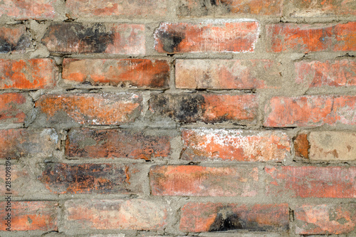 Background of old dirty brick wall with traces of black soot  texture