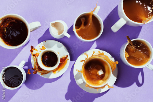 Photos Flatlay of various cups with coffee and creamer on purple background