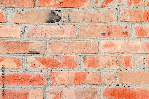 Background of old brick wall with wide messy seams, texture