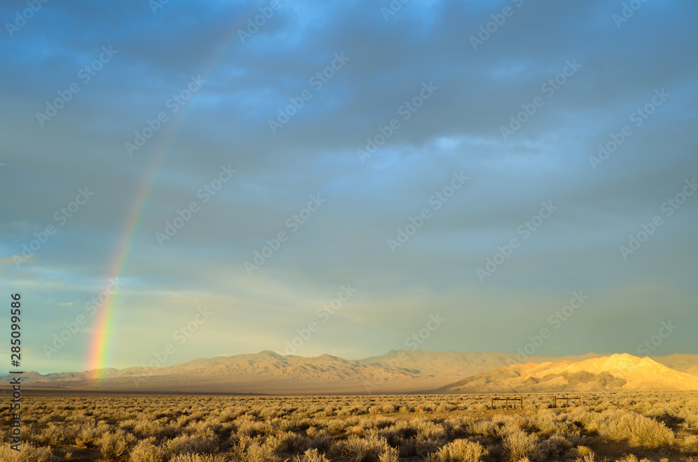 USA, Nevada, Churchill County, Dixie Valley: A rainbow curvers over the  Louderback Mountains, Clan Alpine Range, and sunlit Chalk Mountain Stock  Photo | Adobe Stock