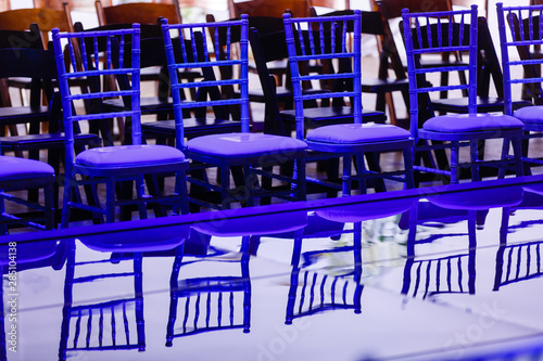 Fotografija Row of blue chairs for VIP guests in front of the shiny edge of stage