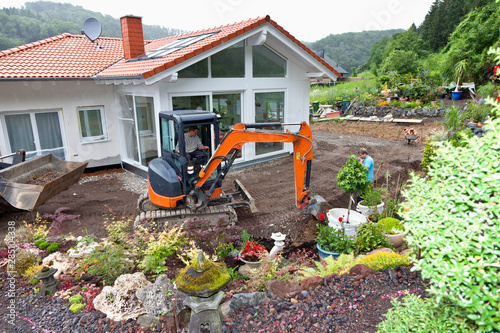Europe, Germany, Rhineland Palatinate, Workers transferring drainage pipe in house building