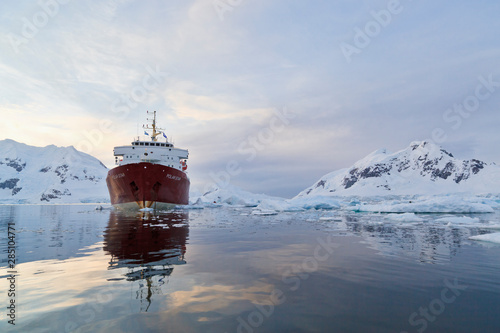 South Atlantic Ocean, Antarctica, Antarctic Peninsula, Gerlache Strait, Paradise Bay, Polar Star icebreaker cruise ship on sea, mountain in background