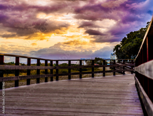 wooden walkway with amaziung sunset on the promenade of marbella on the costa del sol