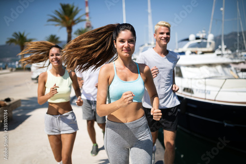 Friends running fitness training together outdoors living active healthy © NDABCREATIVITY