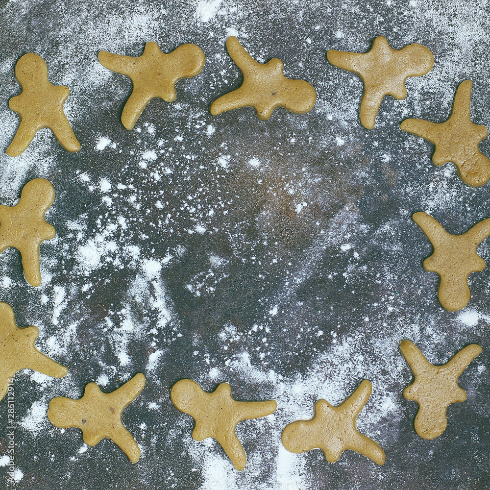Female hands in flour making Christmas cookie in the form of gingerbread man from dough in kitchen. Home baking process Female hands in flour making Christmas cookie in the form of gingerbread man from dough in kitchen. Home baking process