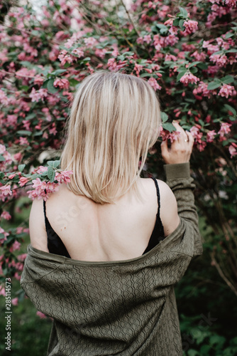 Woman in dress under blooming tree photo