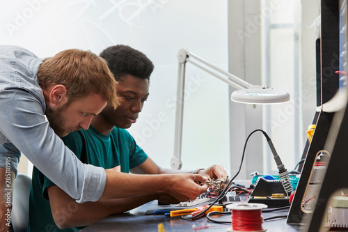 Teacher Assisting Student In Technical Project