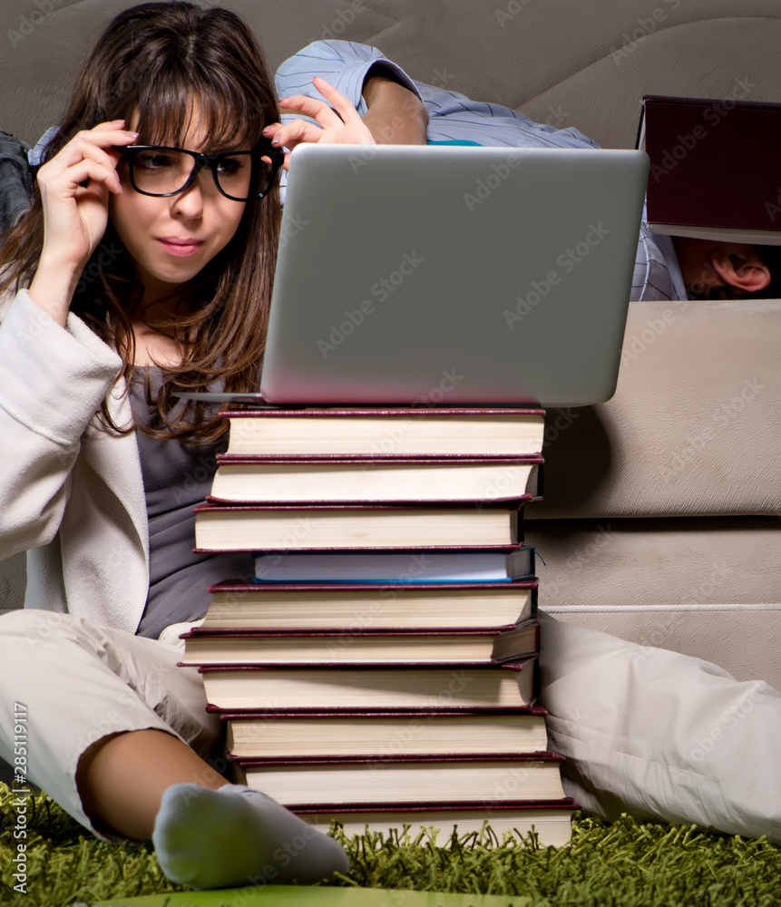 Two students studying late preparing for exams