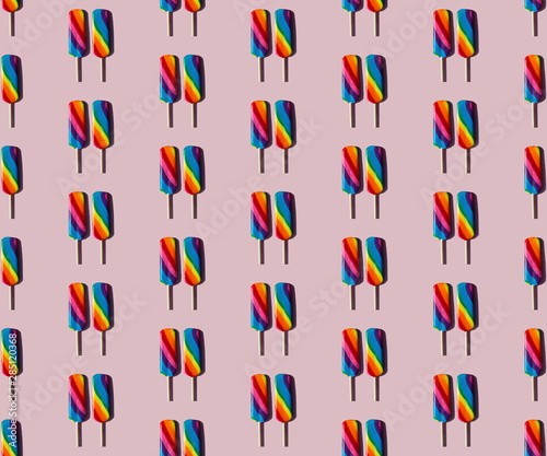 Rainbow lolly candy on a taupe background