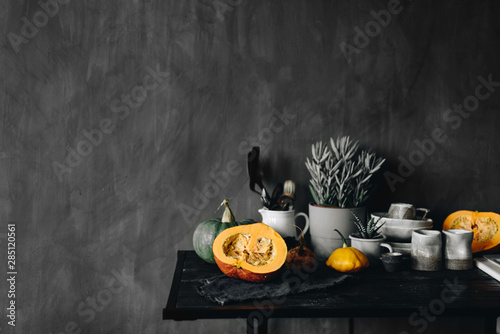 Table with dishware and pumpkins photo