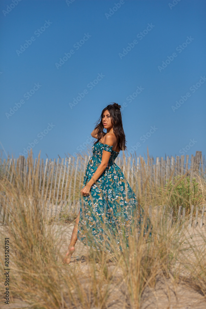 Free happy woman enjoying sun on vacations in dunes..Concept of happiness, enjoyment and well being. Sea, sand and sun. Free happy woman enjoying sun on vacations in dunes..Concept of happiness, enjoyment and well being. Sea, sand and sun.