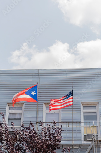 Puerto Rican and American flags flying in Brooklyn photo