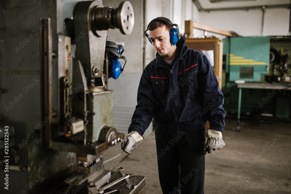 Man working on drilling machine Man working on drilling machine
