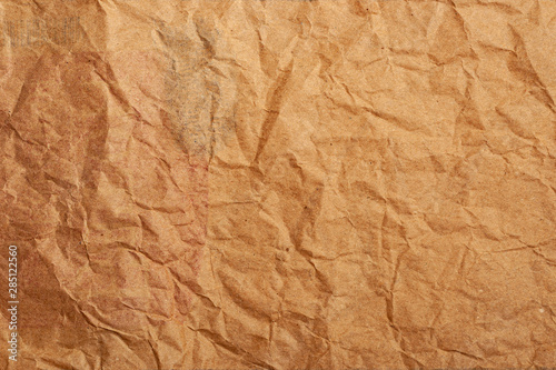 Brown crumpled thick paper for the background. Recycled creased cardboard. Environmentally friendly product.
