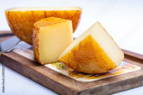 Hard Italian pecorino sheep cheese on wooden board photo