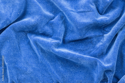 Background in the form of a blue wool product with a pleated pattern, top view