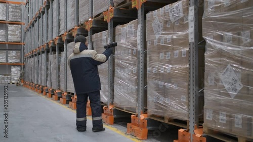 Follow footage of employees male warehouse worker engineer in hard hat working. walking through logistics center warehouse factory construction site logistics architect businessman man builder indoors