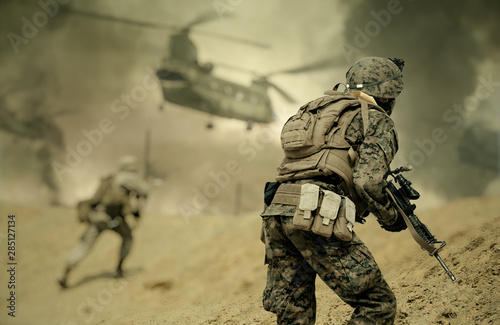 Military forces and helicopters between fire and bombs in battle field