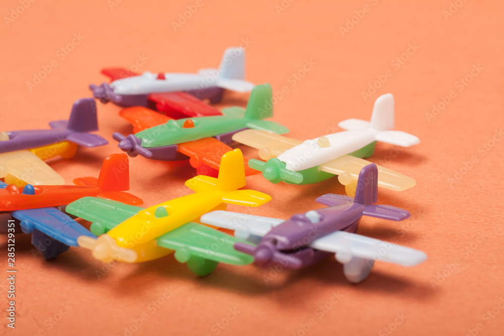 toys plastic aeroplanes on a orange background toys plastic aeroplanes on a orange background