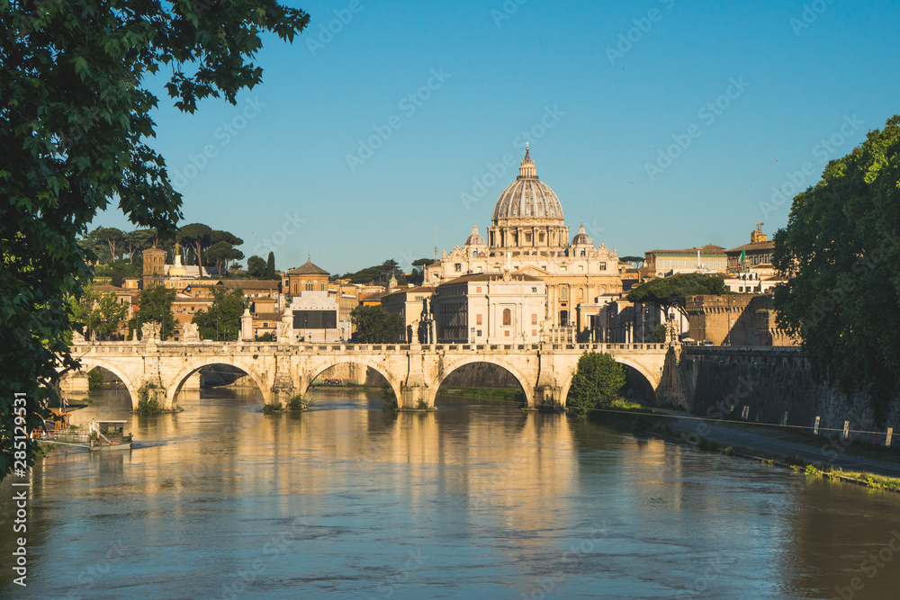 Vatican dome of Saint Peter Basilica (Italian: San Pietro) and Sant'Angelo Bridge, over Tiber river, Rome