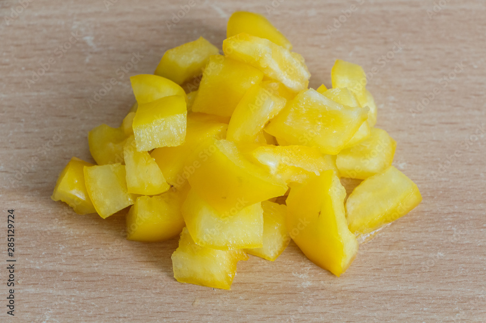 Pieces of yellow pepper on a table Pieces of yellow pepper on a table