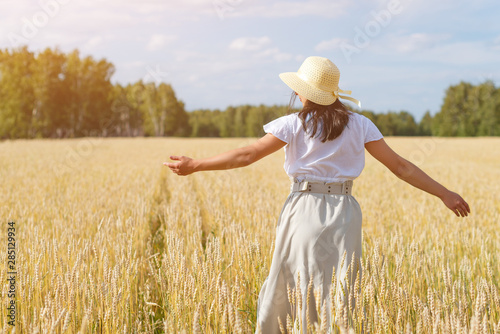 young beautiful woman in golden wheat field. concept of summer, freedom, warmth, harvest, agriculture © mikhail_b_azarov