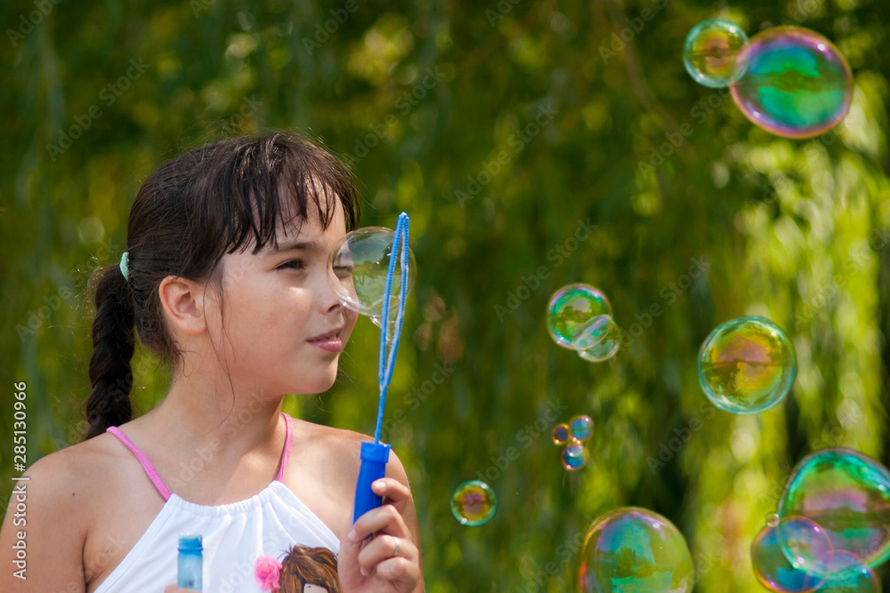 Girl and soap bubbles outdoor at sunrise Girl and soap bubbles outdoor at sunrise