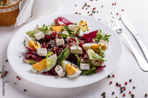 Fresh mixed salad in a bowl on a white background photo