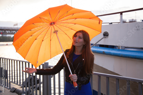 redheaded women under the orange heart shaped umbrella