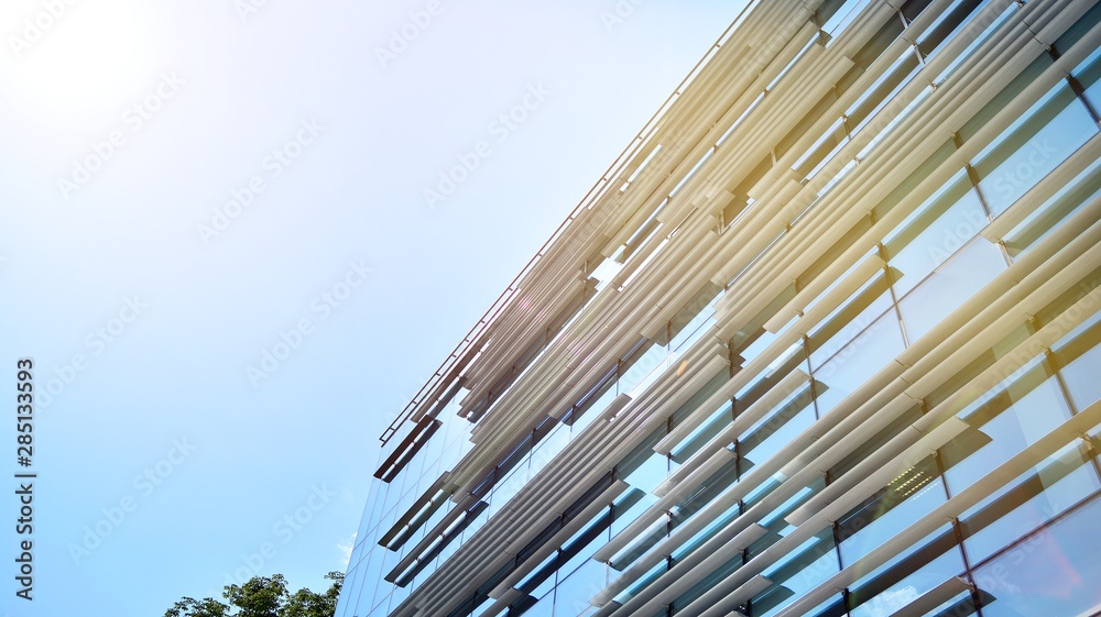 Obraz premium Modern office building detail, glass surface with sunlight