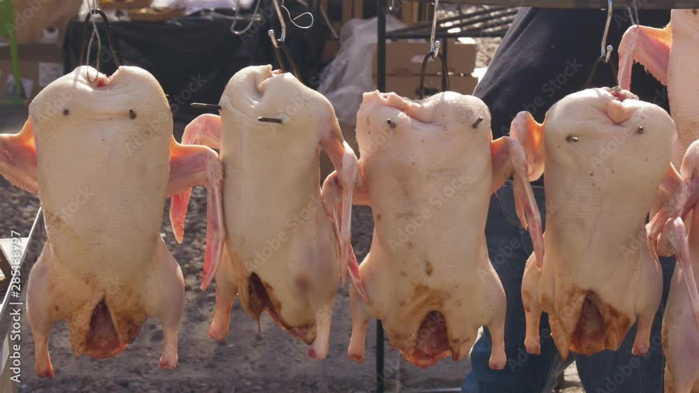 Duck meat sold on the food market on a sunny day. Smoked duck cooking