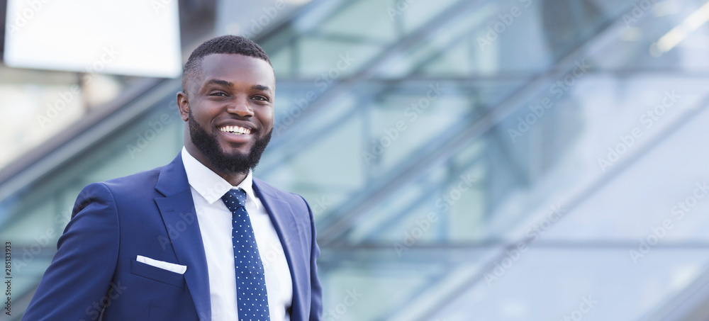 Cheerful Black Business Guy Smiling At Camera In Urban Area Cheerful Black Business Guy Smiling At Camera In Urban Area