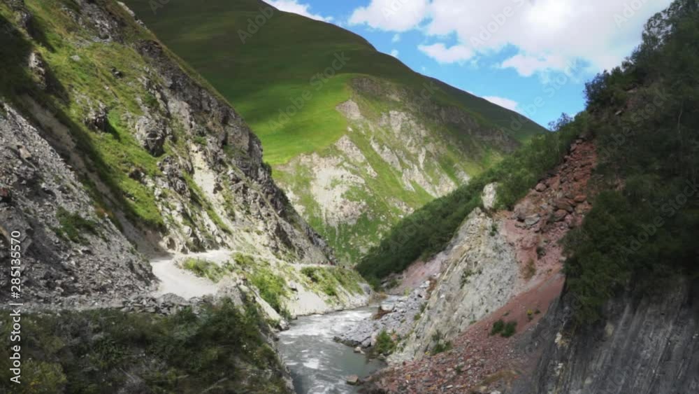 Spring water flowing through rocks in hiking and trekking route in Svaneti, Georgia Spring water flowing through rocks in hiking and trekking route in Svaneti, Georgia